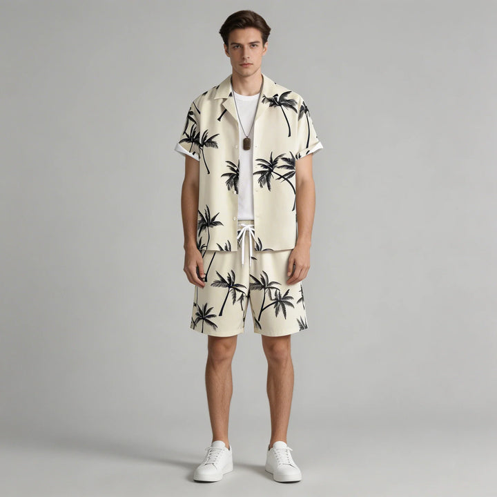 Completo uomo estivo con stampa palma: camicia casual e pantaloncini abbinati, perfetto per la spiaggia o vacanza.