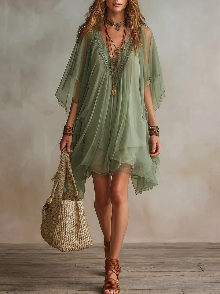 Miniabito fluido donna con scollo a V e maniche kimono; stile boho-chic estivo, elegante e comodo.