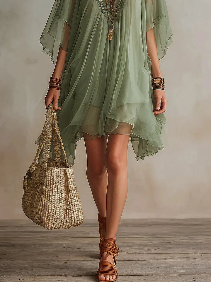 Elegante miniabito fluido da donna, scollo a V profondo, maniche kimono; design estivo versatile e confortevole.