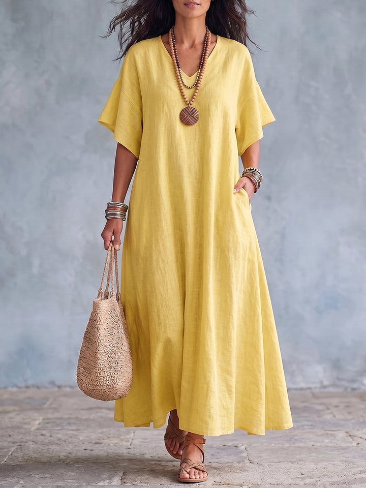 Abito lungo giallo da donna in lino con scollo a V, un capo primaverile/estivo ampio, comodo ed elegante.