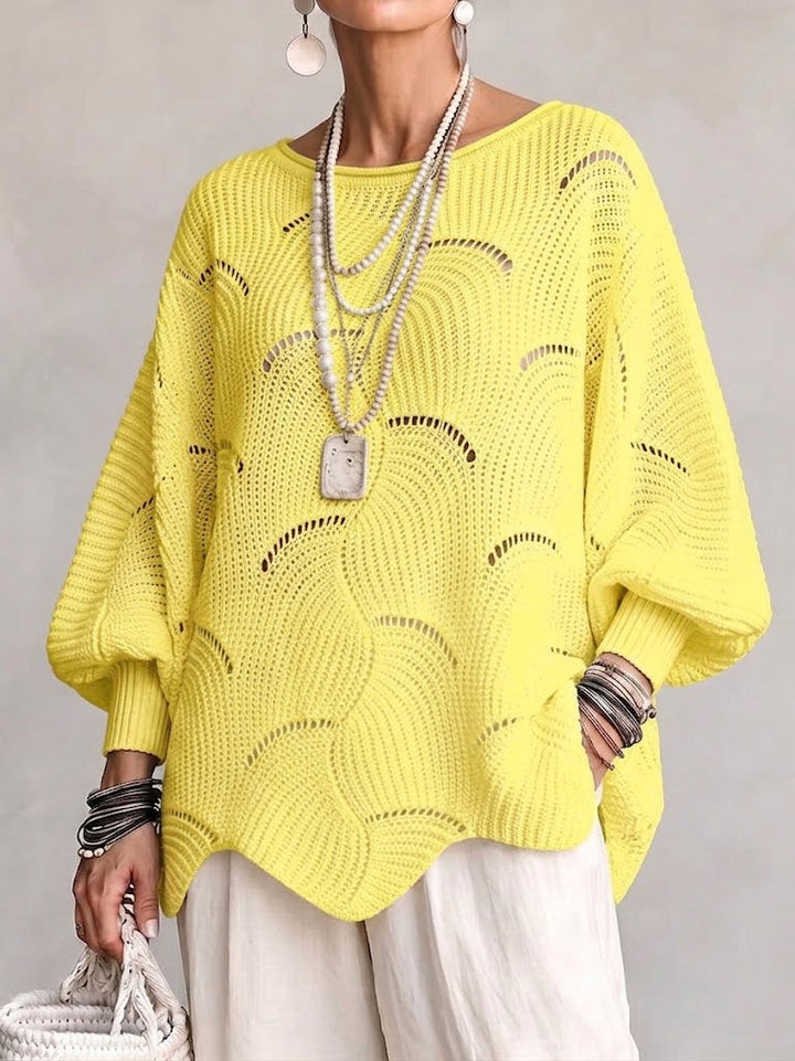 Maglione donna traforato con motivo ondulato e maniche a pipistrello. Vestibilità ampia per massimo comfort.