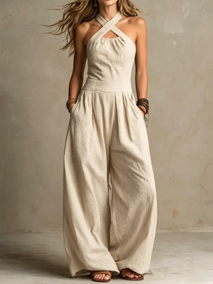 Outfit donna elegante: tuta fluida a gamba ampia con corpetto incrociato, comoda e alla moda per occasioni.