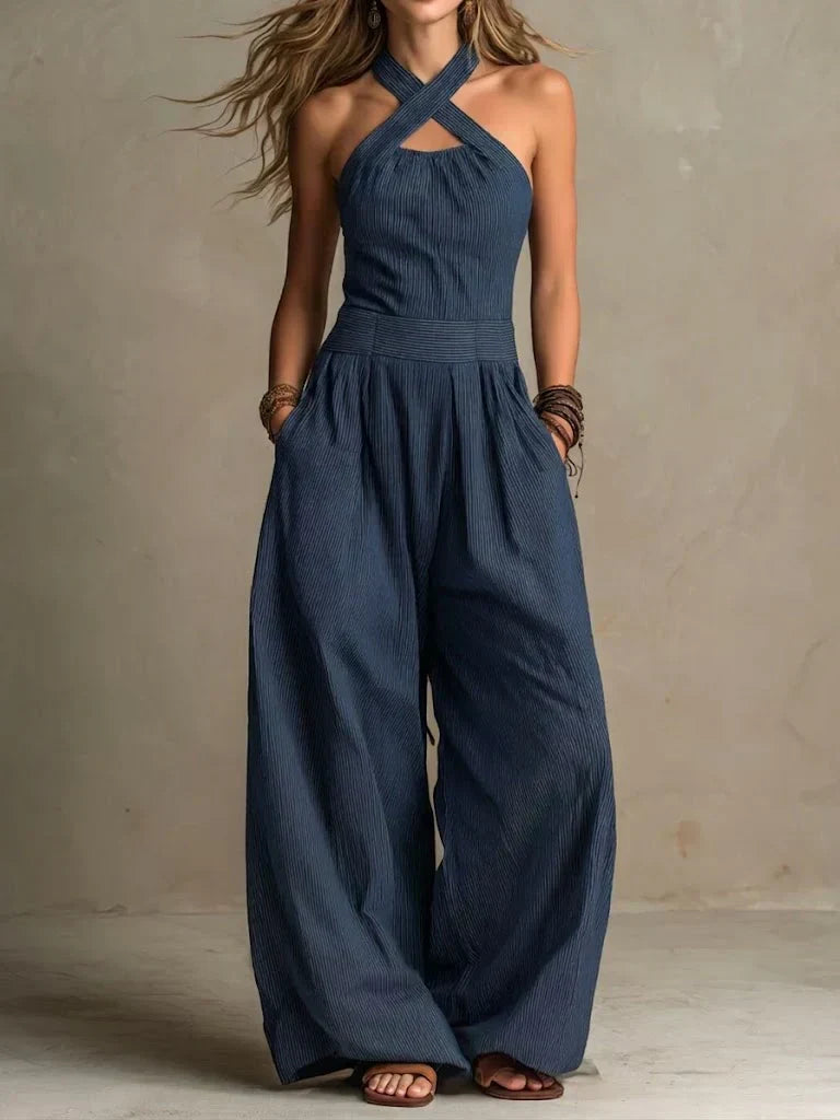 Moderna tuta fluida da donna con design a gamba ampia e corpetto incrociato, perfetta per l'abbigliamento serale.
