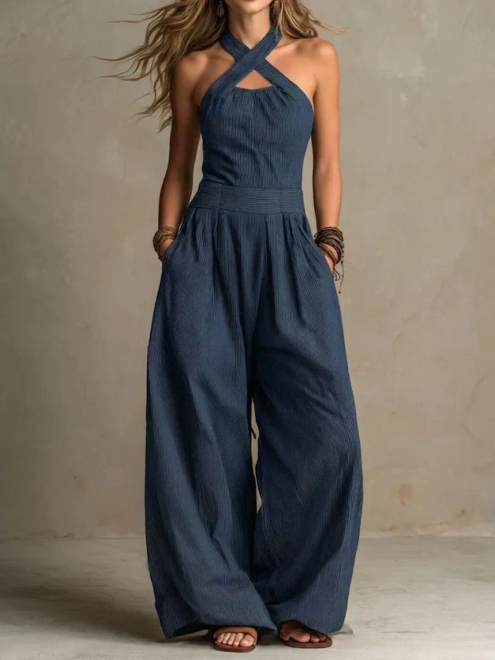 Moderna tuta fluida da donna con design a gamba ampia e corpetto incrociato, perfetta per l'abbigliamento serale.