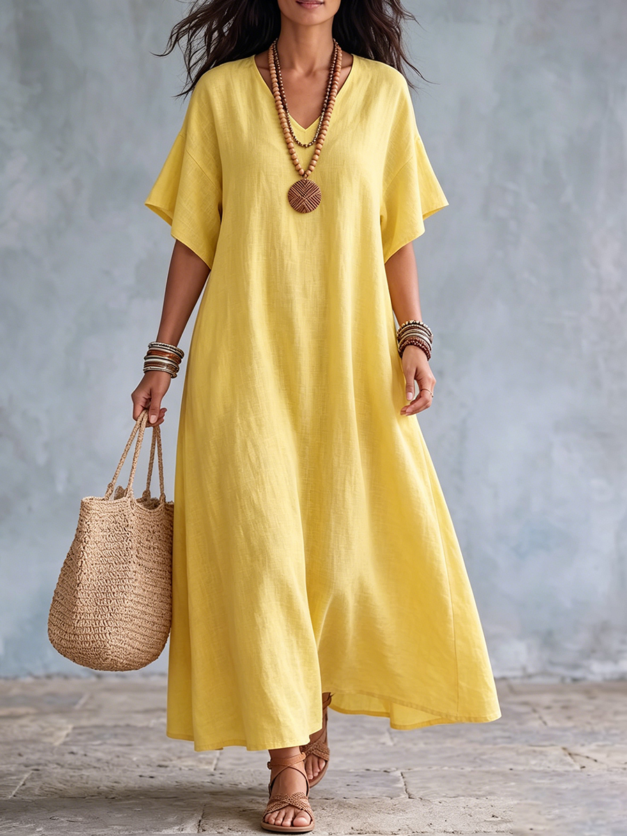 Abito lungo giallo da donna in lino, con scollo a V, ideale per un look estivo elegante e confortevole.