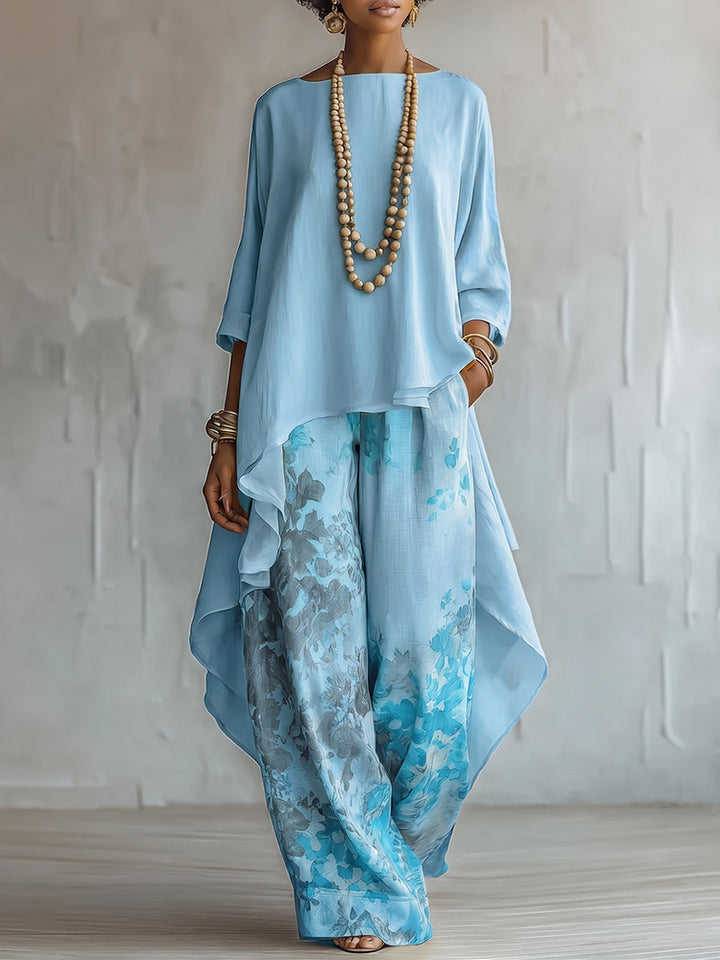 Elegante completo boho donna con blusa asimmetrica e pantaloni floreali. Perfetto per l'outfit resort estivo.