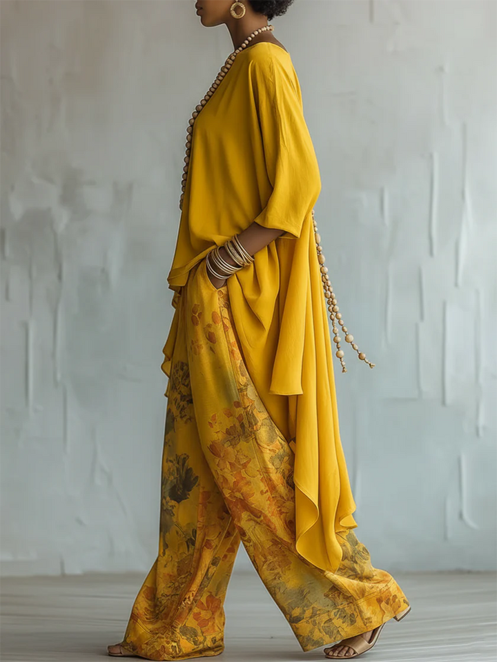 Outfit boho femminile: pantaloni floreali larghi e blusa asimmetrica leggera. Ideale per la moda estiva.