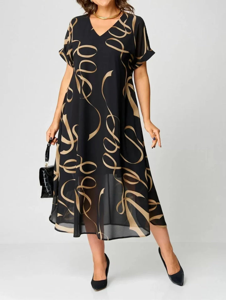 Abito midi donna nero stampato con scollo a V e maniche kimono fluide. Perfetto per look estivi eleganti o casual.