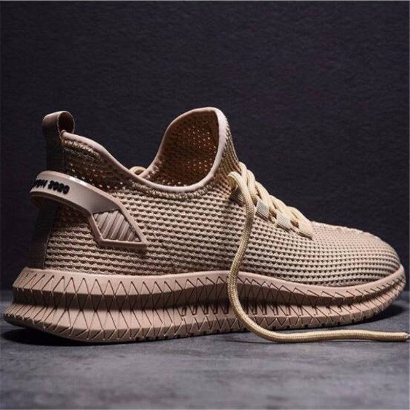 Sneakers uomo grigie, flessibili e ammortizzate, ideali per allenamento leggero e stile casual estivo.