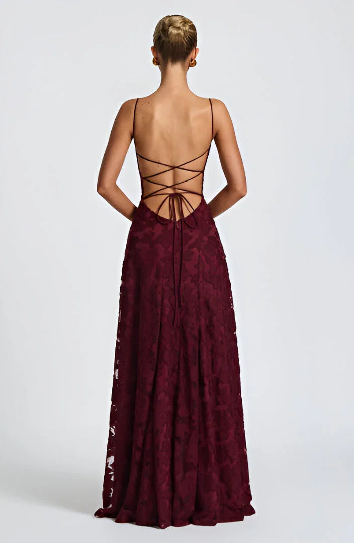 Donna in abito lungo floreale con spalline sottili e schiena scoperta, look elegante e casual estivo.