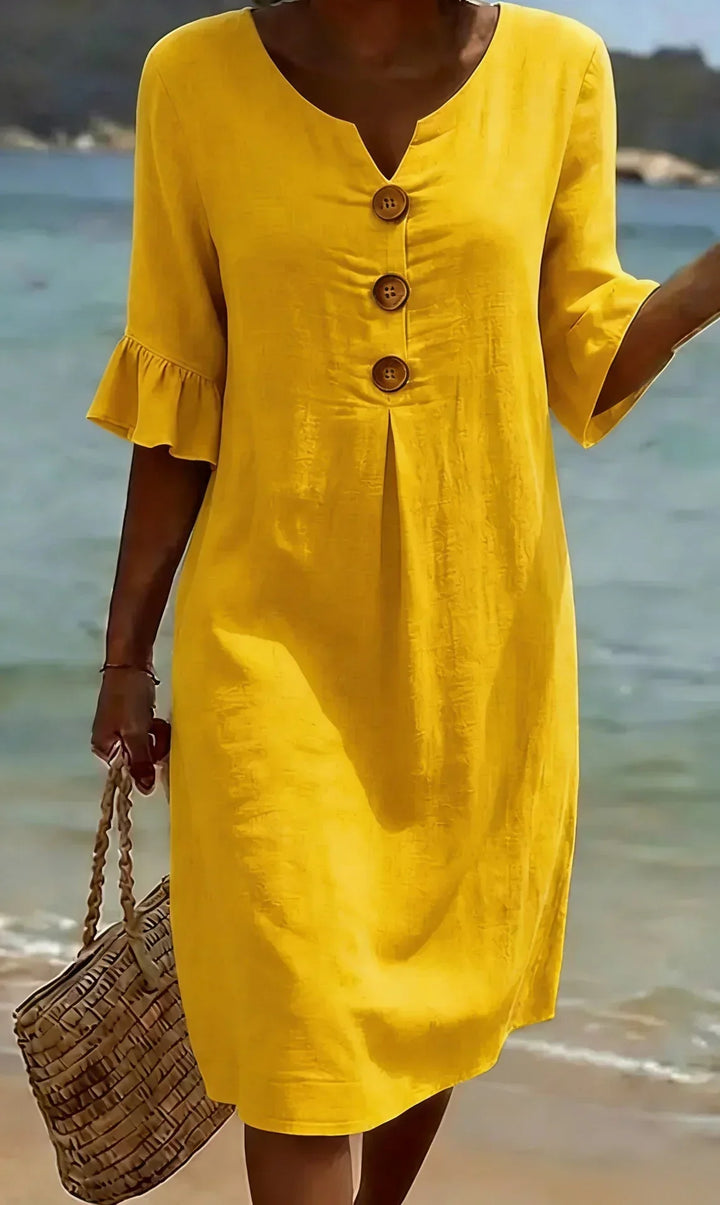 Abito midi donna con scollo a V valorizzante e maniche a volant leggere, un capo moda irrinunciabile.