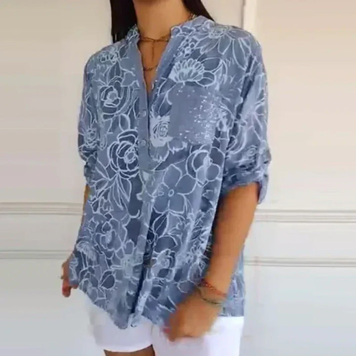 Camicetta donna elegante a maniche lunghe con delicata stampa floreale, perfetta per primavera/estate.