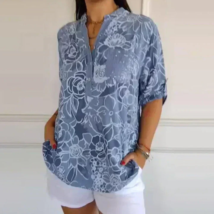 Blusa donna a maniche lunghe, stampa floreale e vestibilità comoda, ideale per look casual o eleganti.