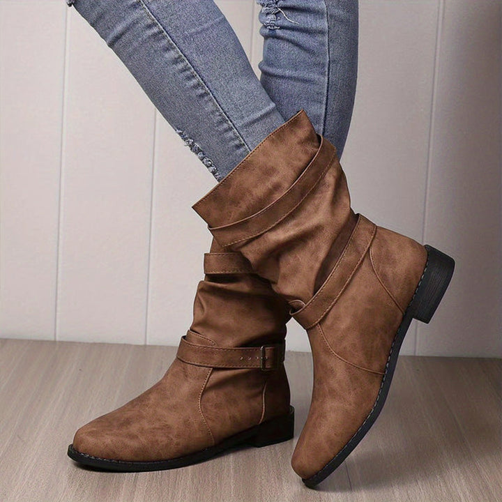 Scarpe donna autunno: stivaletti neri con fibbia e tacco basso. Perfetti per un look sofisticato e pratico.