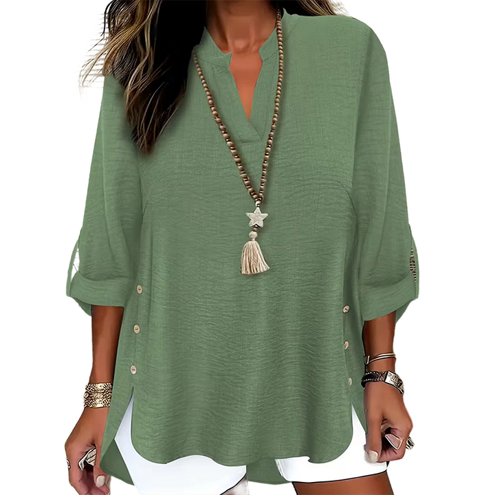 Top donna primaverile con scollo a V, dettagli bottoni laterali, per un outfit raffinato.