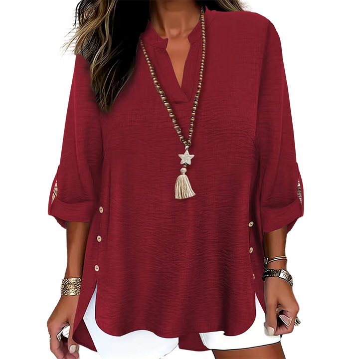 Top donna chic con scollo a V e bottoni, ideale per un look da sera o casual raffinato.