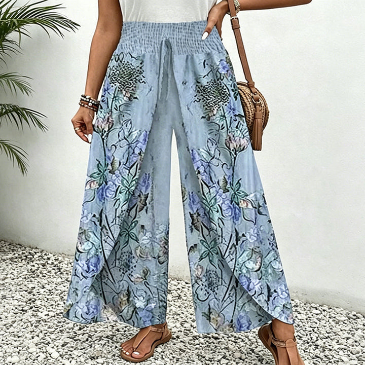 Eleganti pantaloni palazzo floreali da donna con vita arricciata. Ideali per look estivi casual.