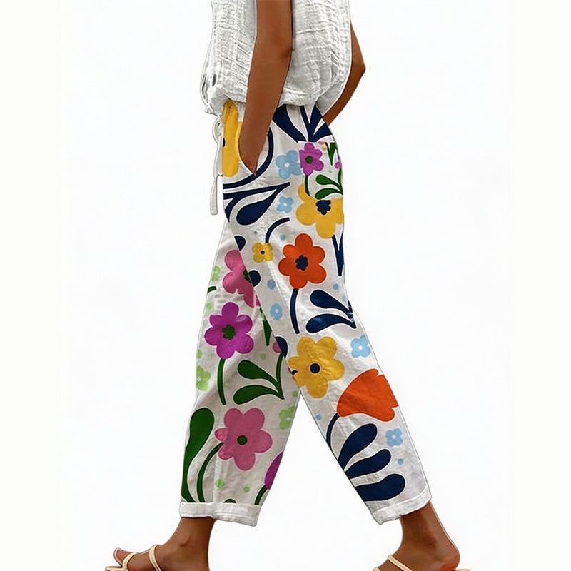 Pantaloni a palazzo floreali da donna, vita alta regolabile, in tessuto leggero e fluido.