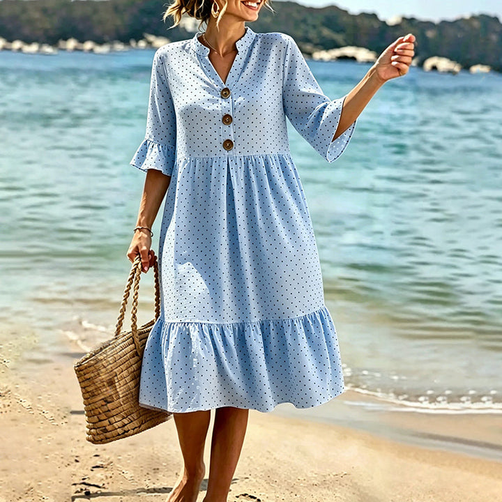 Elegante abito midi donna a pois con volant sull'orlo, ideale per eventi estivi.
