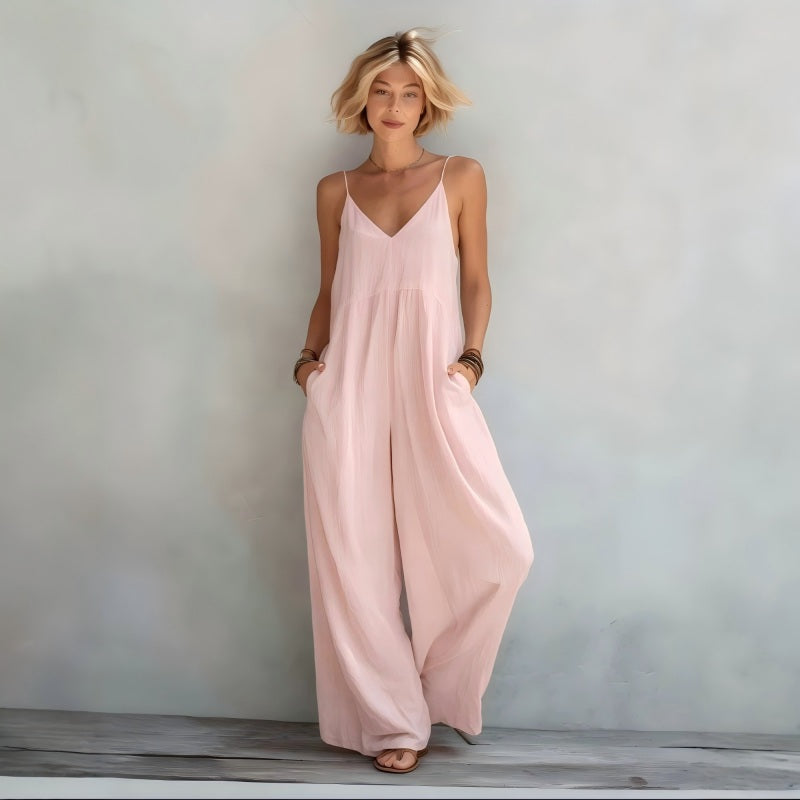 Tuta da donna estiva elegante con scollo a V profondo, gamba ampia e pratiche tasche laterali.