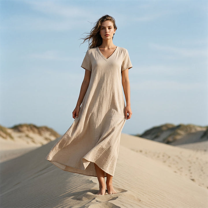 Abito lungo donna elegante scollo a V, ideale per moda estiva raffinata e comoda. Vestito maxi con tasche.