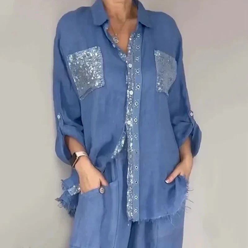 Set completo donna elegante con top paillettes scintillanti e pantaloni fluidi. Ideale per cerimonia.