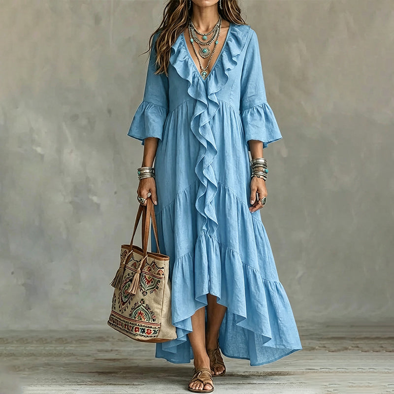 Abito midi donna bohemien con volant e maniche a campana, vista laterale che mostra il taglio fluido.