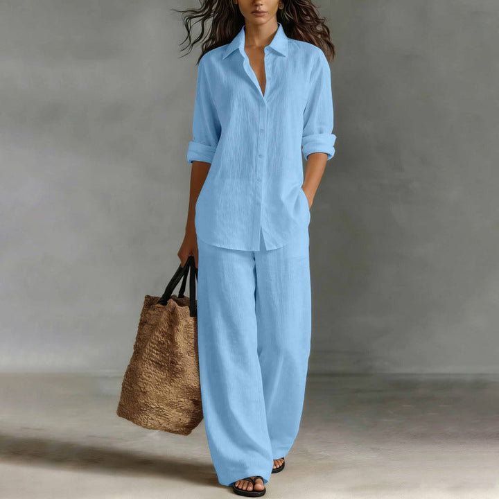 Dettaglio camicia bottonata in tessuto fluido, parte del completo elegante donna.