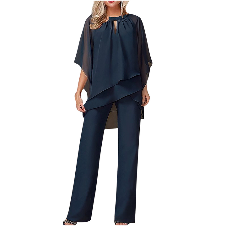 Completo donna elegante con pantaloni ampi e blusa asimmetrica, ideale per outfit cerimonia e serali.