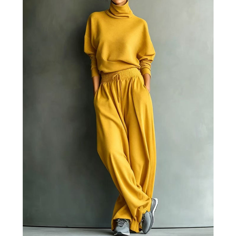 Abbigliamento donna elegante ma comodo, maglia collo alto e pantaloni larghi, ideale per ogni evento.