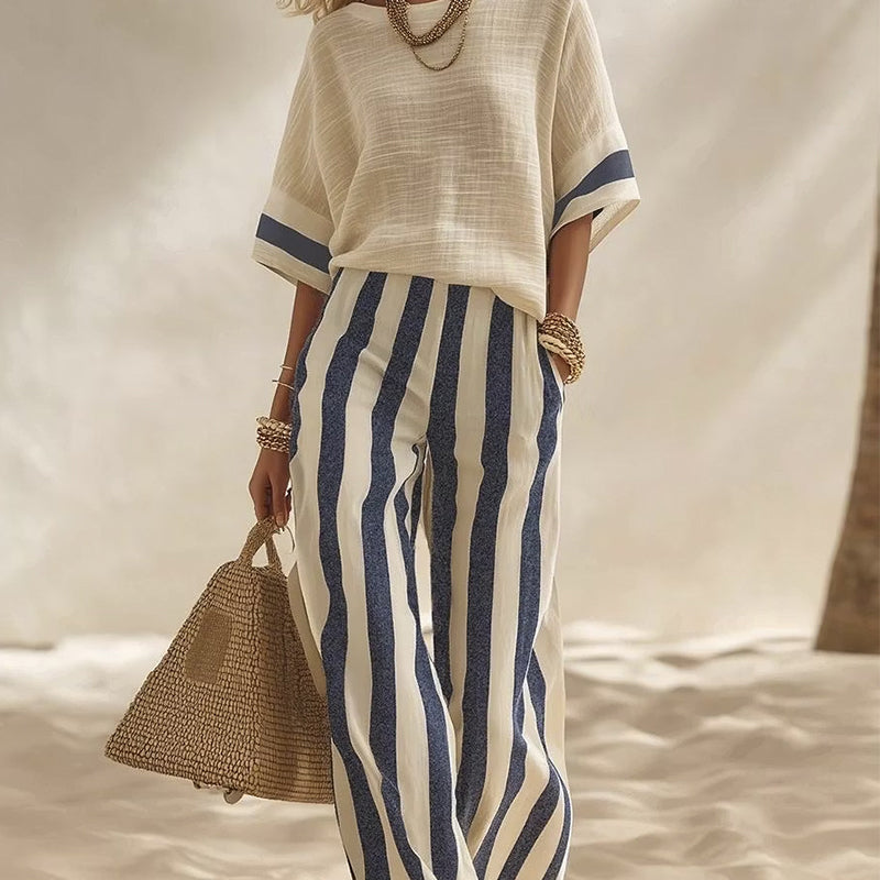 Completo donna estivo elegante, pantaloni larghi a righe e top coordinato.