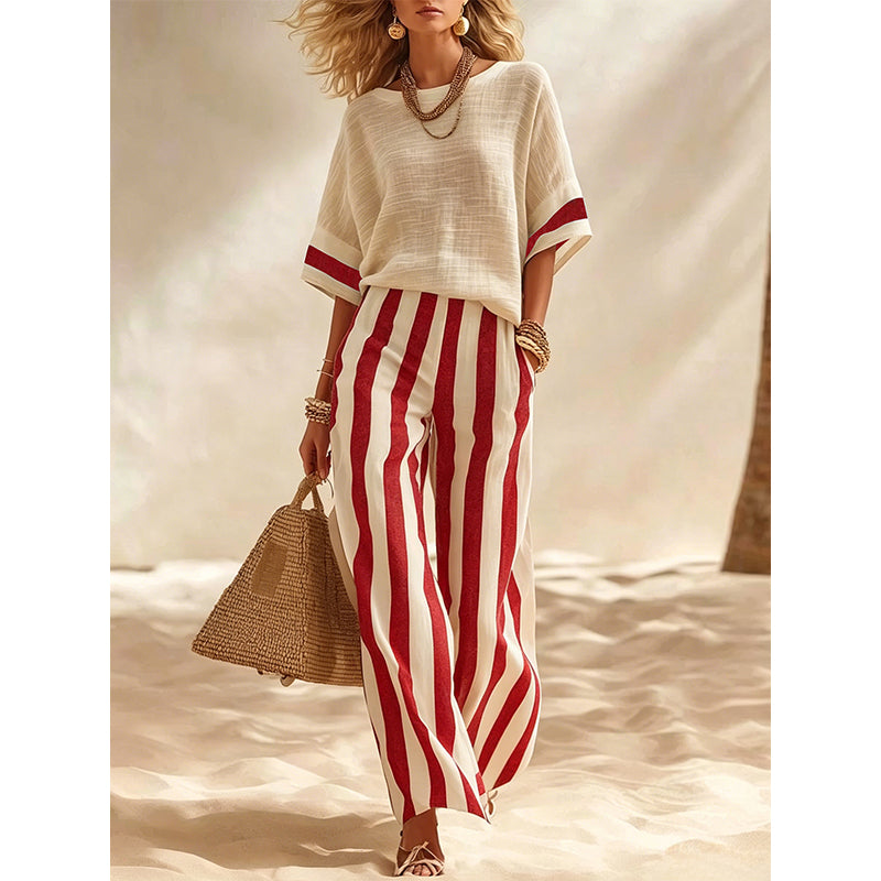 Abbigliamento donna estivo per vacanze, completo elegante a righe con pantaloni fluidi.