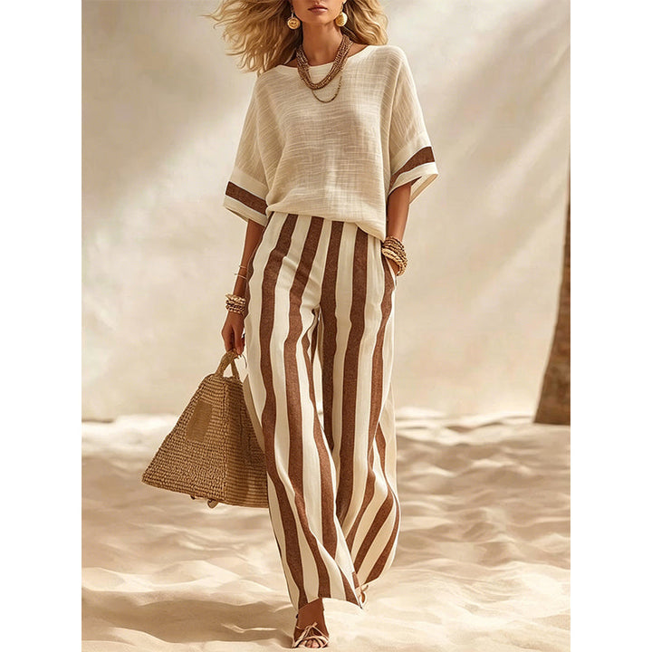 Completo donna estivo elegante, pantaloni ampi a righe per look fresco e di tendenza.