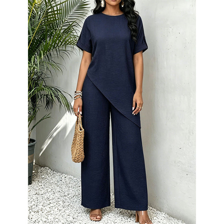 Completo donna due pezzi elegante con top asimmetrico e pantaloni larghi, ideale per primavera ed estate.