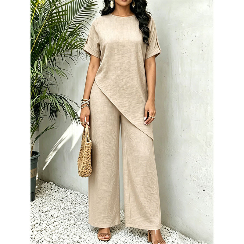 Outfit donna due pezzi versatile con top asimmetrico e comodi pantaloni larghi, perfetto per look casual/chic.
