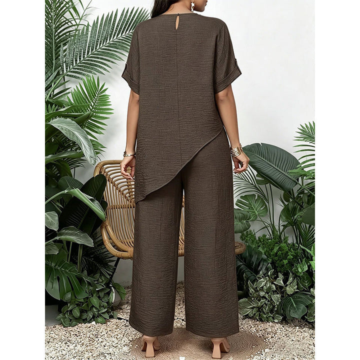 Moda donna primavera/estate: completo due pezzi con top asimmetrico e pantaloni larghi per un outfit moderno.