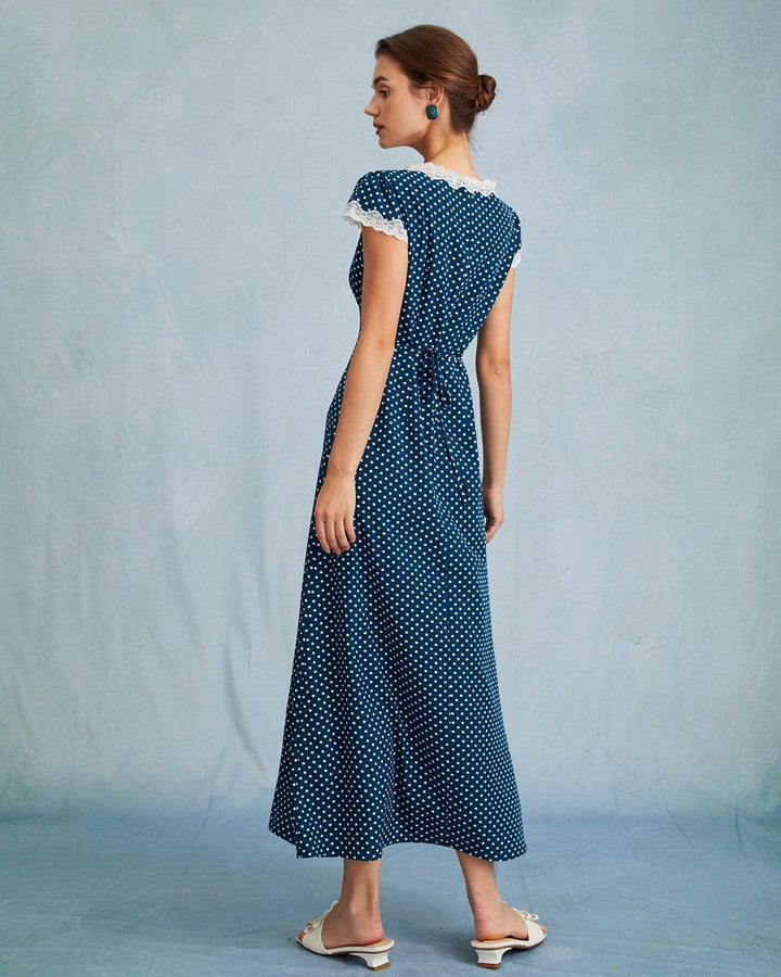 Elegante abito maxi donna blu navy a pois, scollo a V profondo, ideale per vestire con stile ad eventi.