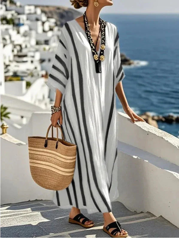 Vestito kaftan donna a righe. Scollo a V, maniche 3/4. Abito lungo fluido, versatile per outfit estivi casual.