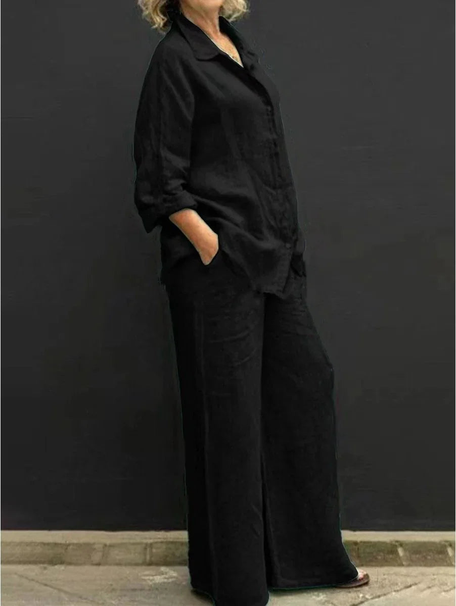 Completo nero elegante, camicia e pantaloni larghi da donna, perfetto per viaggio o eventi casual.
