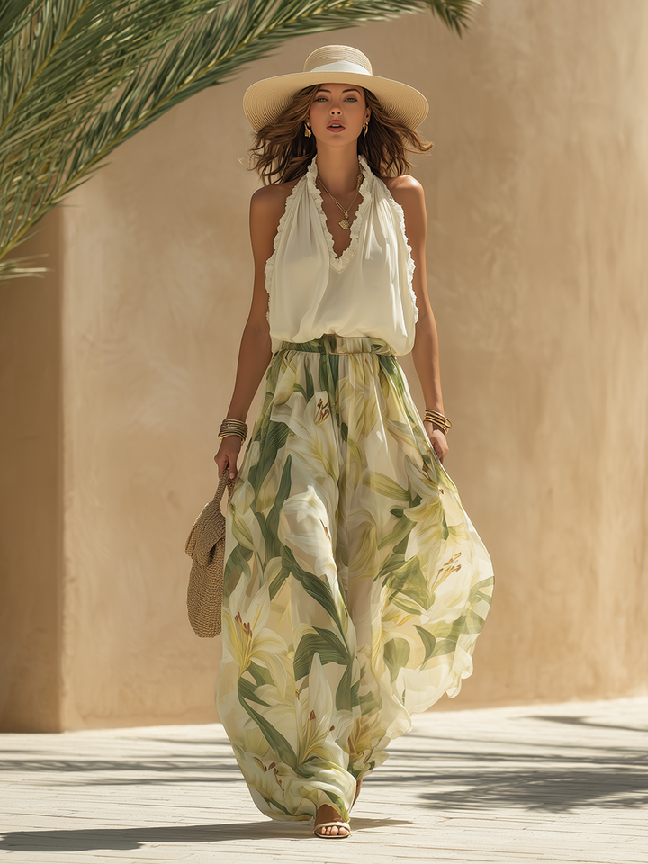 Coordinato donna elegante, perfetto per estate, con top V-neck e ampi pantaloni palazzo fantasia floreale.