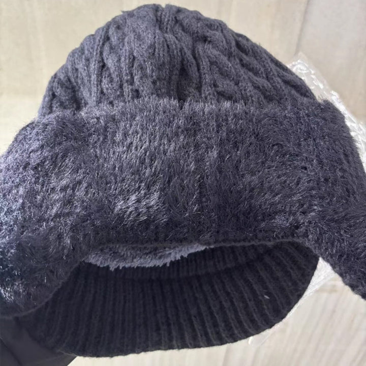 Morbido cappello in maglia invernale, unisex, con visiera e paraorecchie per massimo comfort.