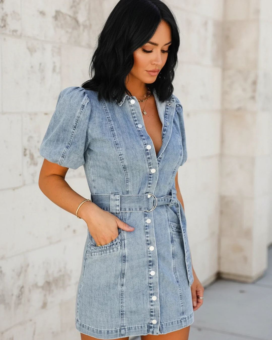Mini abito donna casual-elegante in stile denim con vita cinturata. Maniche a sbuffo per un tocco chic e moderno.