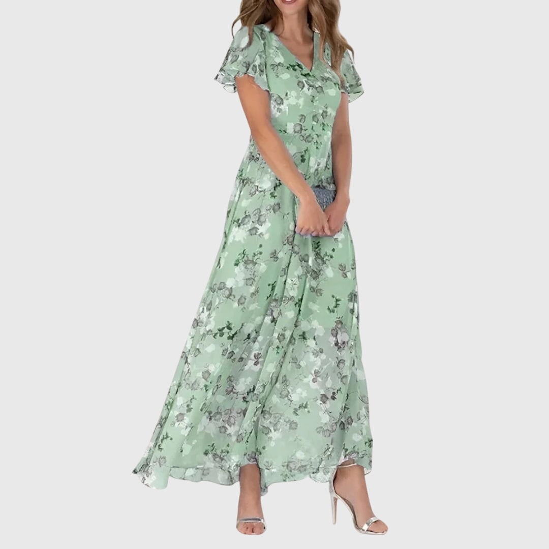 Vestito lungo floreale da donna, stampa vivace. Scollo a V e maniche svolazzanti. Stile estivo elegante e leggero.