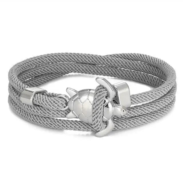 Bracciale donna estivo intrecciato con tartaruga marina in argento e corda turchese, regalo perfetto.