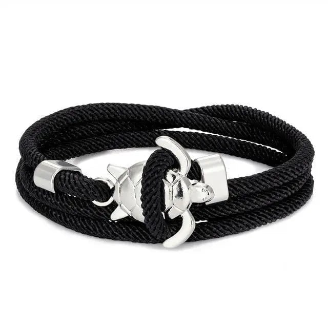 Bracciale donna turchese intrecciato, con un ciondolo dettagliato di tartaruga marina, gioiello estivo.
