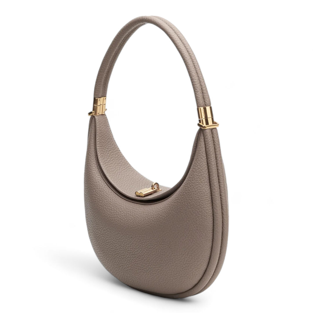 Accessorio moda: borsa a spalla in pelle martellata a mezzaluna. Chiusura girevole e stile versatile per la donna.