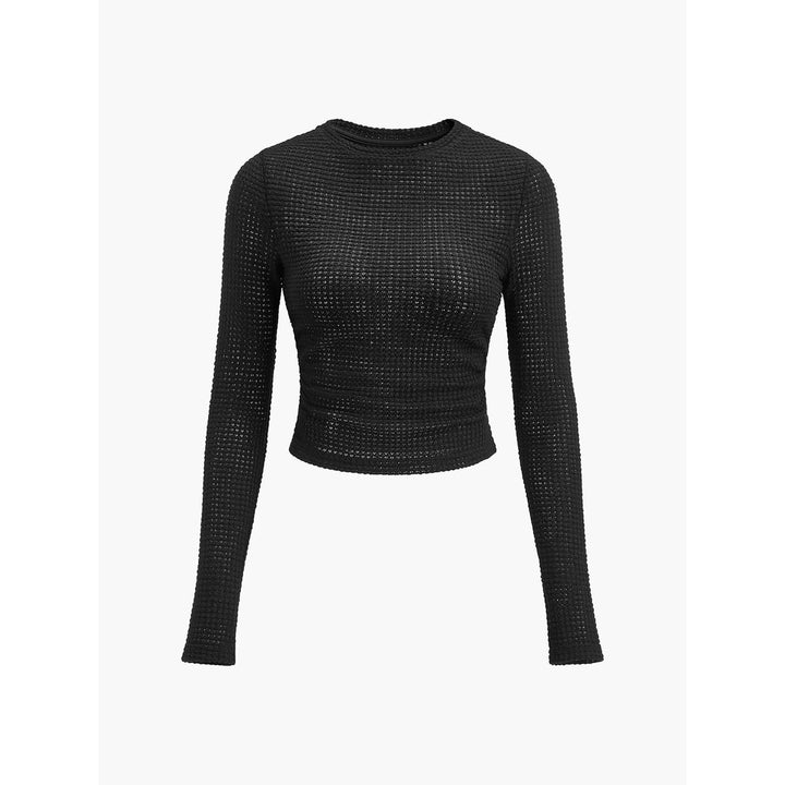 Top crop donna a maniche lunghe color apricot, collo rotondo, vestibilità aderente, abbigliamento femminile essenziale.