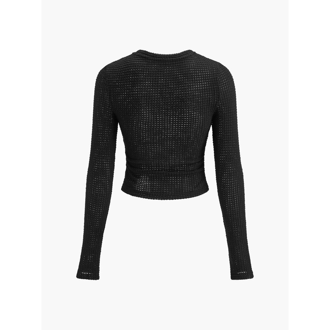 Top donna nero aderente, taglio crop e maniche lunghe, collo rotondo, per un look casual e sofisticato.