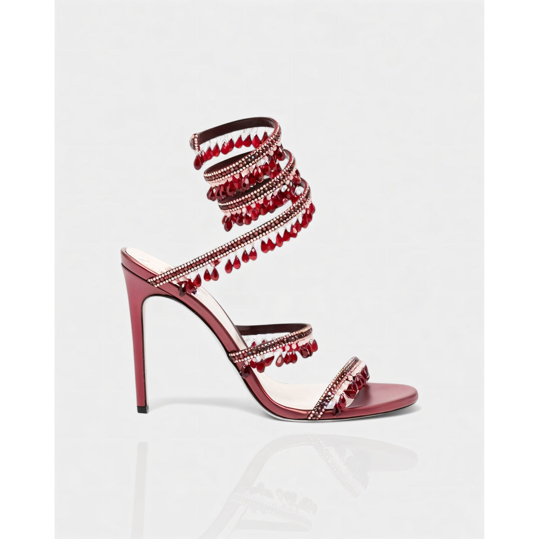 Moda sera donna: stiletto eleganti con fascia alla caviglia e nappe scintillanti.