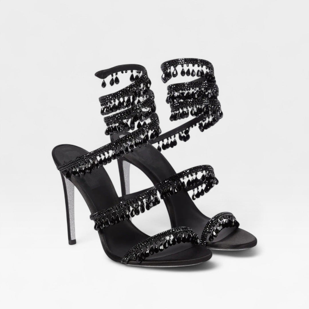 Calzature donna eleganti con tacchi a spillo e scintillanti cristalli sul cinturino a spirale.